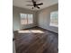 Bedroom with wood-look flooring, ceiling fan, and a lot of natural light at 1250 Adamson Rd, Bowdon, GA 30108