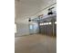 Spacious garage with white walls and a concrete floor, featuring garage door openers at 1250 Adamson Rd, Bowdon, GA 30108