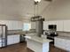 Modern kitchen featuring white cabinets, granite countertops, stainless steel appliances, and a center island at 1250 Adamson Rd, Bowdon, GA 30108