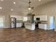 Open-concept kitchen and living area with stainless steel appliances, granite countertops, and wood flooring at 1250 Adamson Rd, Bowdon, GA 30108