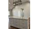 Kitchen island with granite countertop and white drawers, with open space for dining or gathering at 1250 Adamson Rd, Bowdon, GA 30108