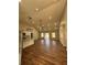 An open living room and kitchen area with hardwood floors and high ceilings at 1250 Adamson Rd, Bowdon, GA 30108