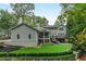 Expansive backyard with lush lawn, stone landscaping, mature trees, and a multi-level deck perfect for entertaining at 2908 Mabry Ne Ln, Brookhaven, GA 30319