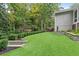 Lush backyard featuring artificial turf, manicured hedges, and stone retaining walls, providing a serene outdoor space at 2908 Mabry Ne Ln, Brookhaven, GA 30319