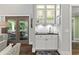 Chic bar area with glass shelving, mosaic backsplash, and custom cabinetry at 2908 Mabry Ne Ln, Brookhaven, GA 30319