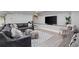 Basement has a grey leather couch, patterned rug, and a large flat screen TV at 2908 Mabry Ne Ln, Brookhaven, GA 30319
