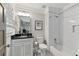 Bathroom features a white vanity with a black countertop and a tub with a white tile surround at 2908 Mabry Ne Ln, Brookhaven, GA 30319