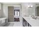 Elegant bathroom with soaking tub, marble floors, and a view to bedroom with natural light at 2908 Mabry Ne Ln, Brookhaven, GA 30319