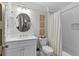 This bathroom has a white vanity, oval mirror, and a shower with white tile surround at 2908 Mabry Ne Ln, Brookhaven, GA 30319
