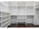 Walk in closet featuring custom shelving and dark hardwood floors at 2908 Mabry Ne Ln, Brookhaven, GA 30319