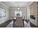 Elegant dining room featuring a modern chandelier, brick fireplace, and large windows at 2908 Mabry Ne Ln, Brookhaven, GA 30319