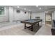 Finished basement game room with a modern pool table and luxury vinyl plank flooring at 2908 Mabry Ne Ln, Brookhaven, GA 30319