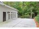 Exterior of the garage featuring a wide driveway and mature landscaping at 2908 Mabry Ne Ln, Brookhaven, GA 30319
