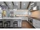 Bright kitchen features white cabinets, marble counters, a stainless hood, dark floors and wood beam details at 2908 Mabry Ne Ln, Brookhaven, GA 30319