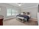 A serene main bedroom with a tray ceiling, plush carpet, and a window with shutters at 2908 Mabry Ne Ln, Brookhaven, GA 30319