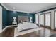 Elegant main bedroom with a tufted headboard, hardwood floors, and French doors, creating a luxurious retreat at 2908 Mabry Ne Ln, Brookhaven, GA 30319