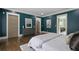 Nicely appointed main bedroom with a view into the bath and featuring hardwood floors, gray dresser, and white trim at 2908 Mabry Ne Ln, Brookhaven, GA 30319