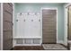 Mudroom featuring a built-in bench, coat hooks, and a stylish door to the exterior at 2908 Mabry Ne Ln, Brookhaven, GA 30319