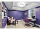 A well-lit, purple home office features built-in shelves, modern desk, and lots of natural light at 2908 Mabry Ne Ln, Brookhaven, GA 30319
