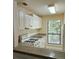 Efficient kitchen featuring white cabinets, and an open view to another room at 613 Wynnes Ridge Cir, Marietta, GA 30067