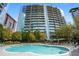 Community pool area with lounge chairs and green trees, perfect for relaxation at 44 Peachtree Ne Pl # 424, Atlanta, GA 30309