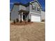 Charming gray two-story home with a white garage door, black shutters, and manicured front yard at 8647 Paradise Dr, Douglasville, GA 30134