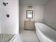 Bright bathroom featuring a freestanding tub, separate shower, and a modern vanity at 2924 Sylvan Rd, East Point, GA 30344