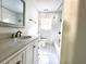 Bright bathroom with tiled shower over tub and vanity with granite counter at 2924 Sylvan Rd, East Point, GA 30344