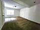 Neutral carpeted bedroom offers natural light from a window and ample closet space at 2924 Sylvan Rd, East Point, GA 30344