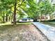 Well-maintained single-story home with a long driveway nestled among mature trees at 2924 Sylvan Rd, East Point, GA 30344
