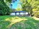 Charming home with a deck and a well-maintained lawn, surrounded by lush trees at 2924 Sylvan Rd, East Point, GA 30344