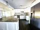 Bright kitchen featuring granite countertops, white cabinets, and stainless steel appliances at 2924 Sylvan Rd, East Point, GA 30344