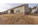 Backyard view of house with beige siding and covered patio at 4444 Kendrick Cir, Loganville, GA 30052