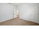 A bedroom with neutral walls and carpet, and a door opening to a bathroom at 4444 Kendrick Cir, Loganville, GA 30052