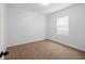 This bedroom features neutral carpeting and a window providing natural light at 4444 Kendrick Cir, Loganville, GA 30052