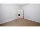 A bedroom with neutral walls and carpet, and a door opening to a bathroom at 4444 Kendrick Cir, Loganville, GA 30052
