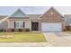 Charming one-story home featuring brick and siding exterior, manicured lawn and a two car garage at 4444 Kendrick Cir, Loganville, GA 30052
