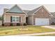 Charming one-story home featuring brick and siding exterior, manicured lawn and a two car garage at 4444 Kendrick Cir, Loganville, GA 30052