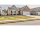 Charming one-story home featuring brick and siding exterior, manicured lawn and a two car garage at 4444 Kendrick Cir, Loganville, GA 30052