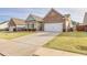 Charming one-story home featuring brick and siding exterior, manicured lawn and a two car garage at 4444 Kendrick Cir, Loganville, GA 30052