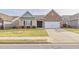 Charming one-story home featuring brick and siding exterior, manicured lawn and a two car garage at 4444 Kendrick Cir, Loganville, GA 30052