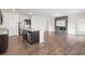 Spacious living room featuring a modern fireplace, granite countertop kitchen island, and hardwood floors at 4444 Kendrick Cir, Loganville, GA 30052