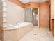 Elegant bathroom with soaking tub, glass shower, and marble tile at 3334 Peachtree Ne Rd # 1707, Atlanta, GA 30326
