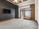 Spacious bedroom with large window, exposed brick wall and ceiling fan at 3334 Peachtree Ne Rd # 1707, Atlanta, GA 30326