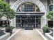 Elegant building entrance with arched windows and landscaping at 3334 Peachtree Ne Rd # 1707, Atlanta, GA 30326