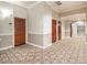 Well-lit hallway with patterned carpet and classic doors leading to residences at 3334 Peachtree Ne Rd # 1707, Atlanta, GA 30326