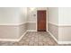 Apartment hallway with neutral walls, detailed trim, and patterned flooring at 3334 Peachtree Ne Rd # 1707, Atlanta, GA 30326