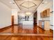 Open-concept living room and kitchen with hardwood floors, modern appliances, and designer lighting at 3334 Peachtree Ne Rd # 1707, Atlanta, GA 30326