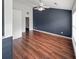 Bedroom with ceiling fan, laminate floors, and a dark accent wall with a closet is bright and modern at 1190 Se Village Se Ct, Atlanta, GA 30316