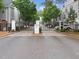 View of the community entrance featuring decorative brick pillars, an iron gate, and manicured landscaping at 1190 Se Village Se Ct, Atlanta, GA 30316